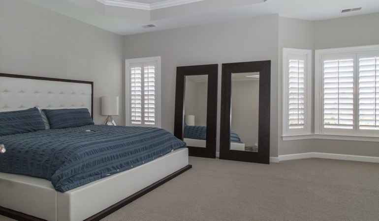 White shutters in a minimalist bedroom in Boise.